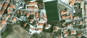 Aerial view of an intervention area featuring residential buildings, a football field, and surrounding greenery, highlighting urban layout and amenities.