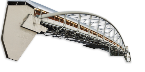 A modern architectural bridge showcasing sleek design and structural elegance, featuring a curved arch and illuminated pathway.